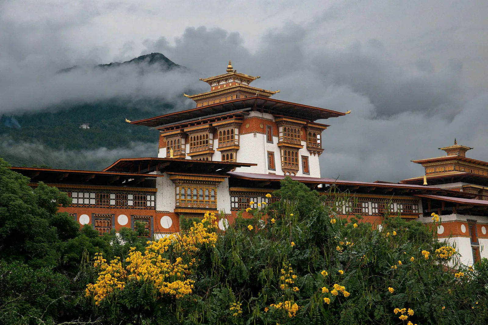 Punakha Dzong beneath misty mountains in Bhutan